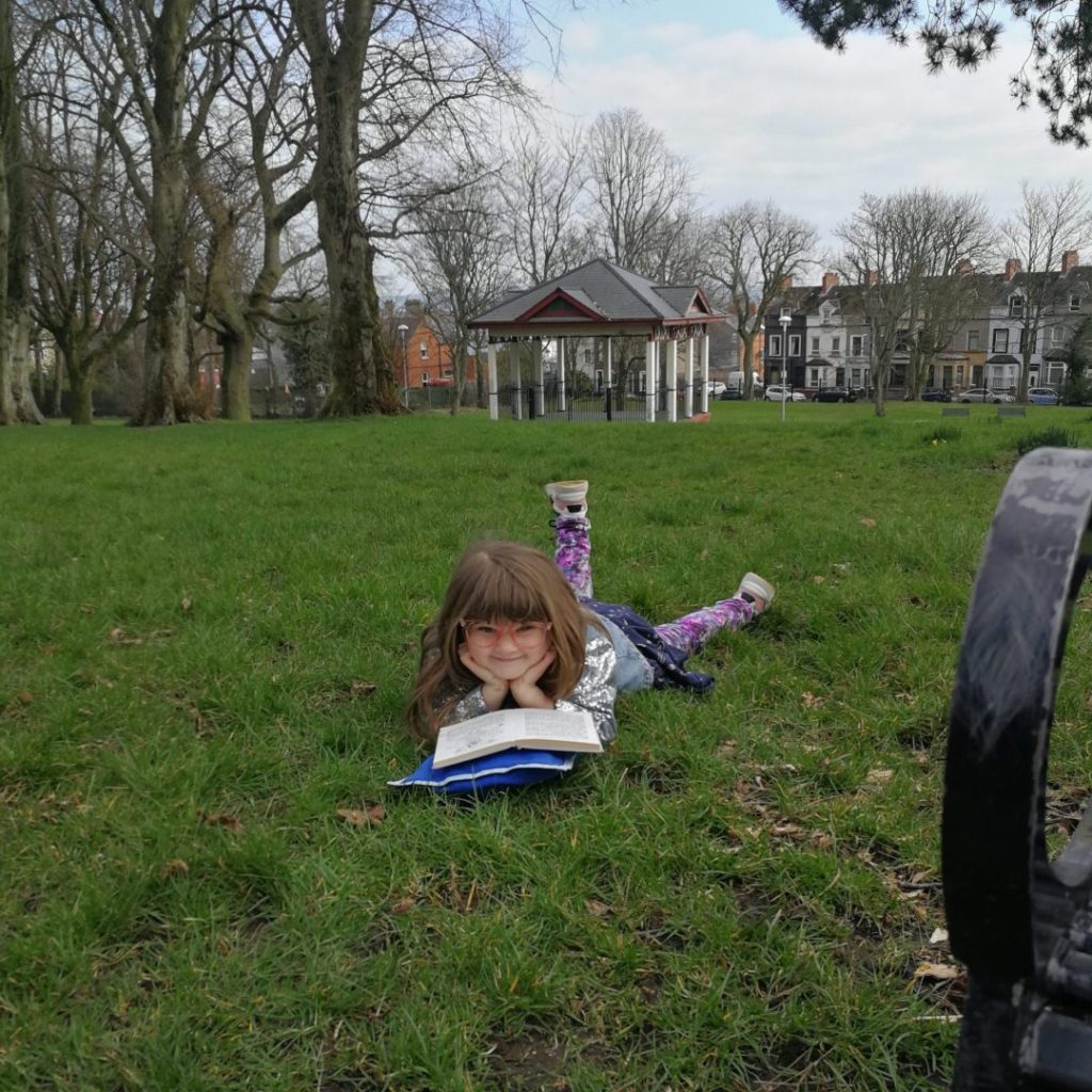 Young girl reading in the park