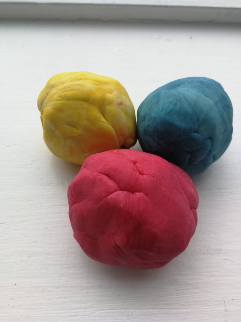 The Primary Colours using playdoh sitting on a table