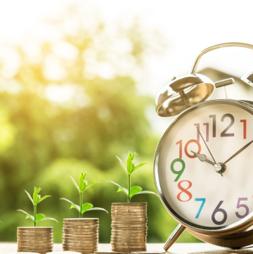 Image with money and a clock representing funding for education